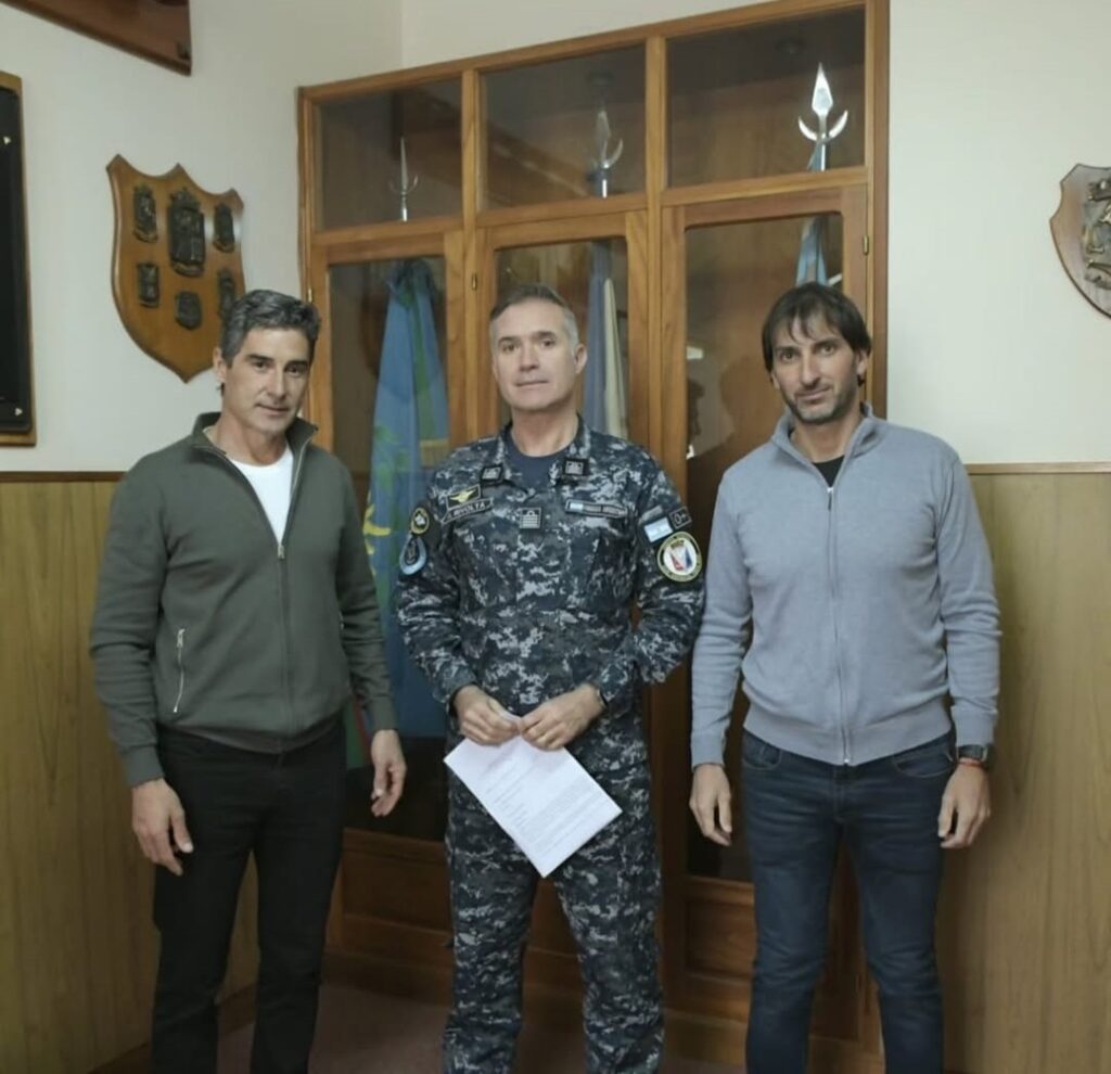 hernan yzurieta le entrega al jefe de la base aeronaval punta indio un documento en el que se compromete a repavimentar la pista de aterrizaje